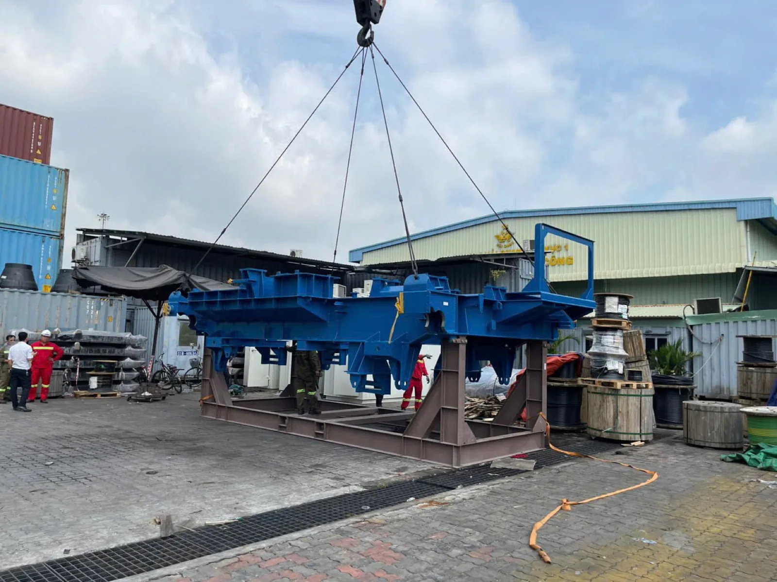 Large machinery structure being positioned by crane at the factory