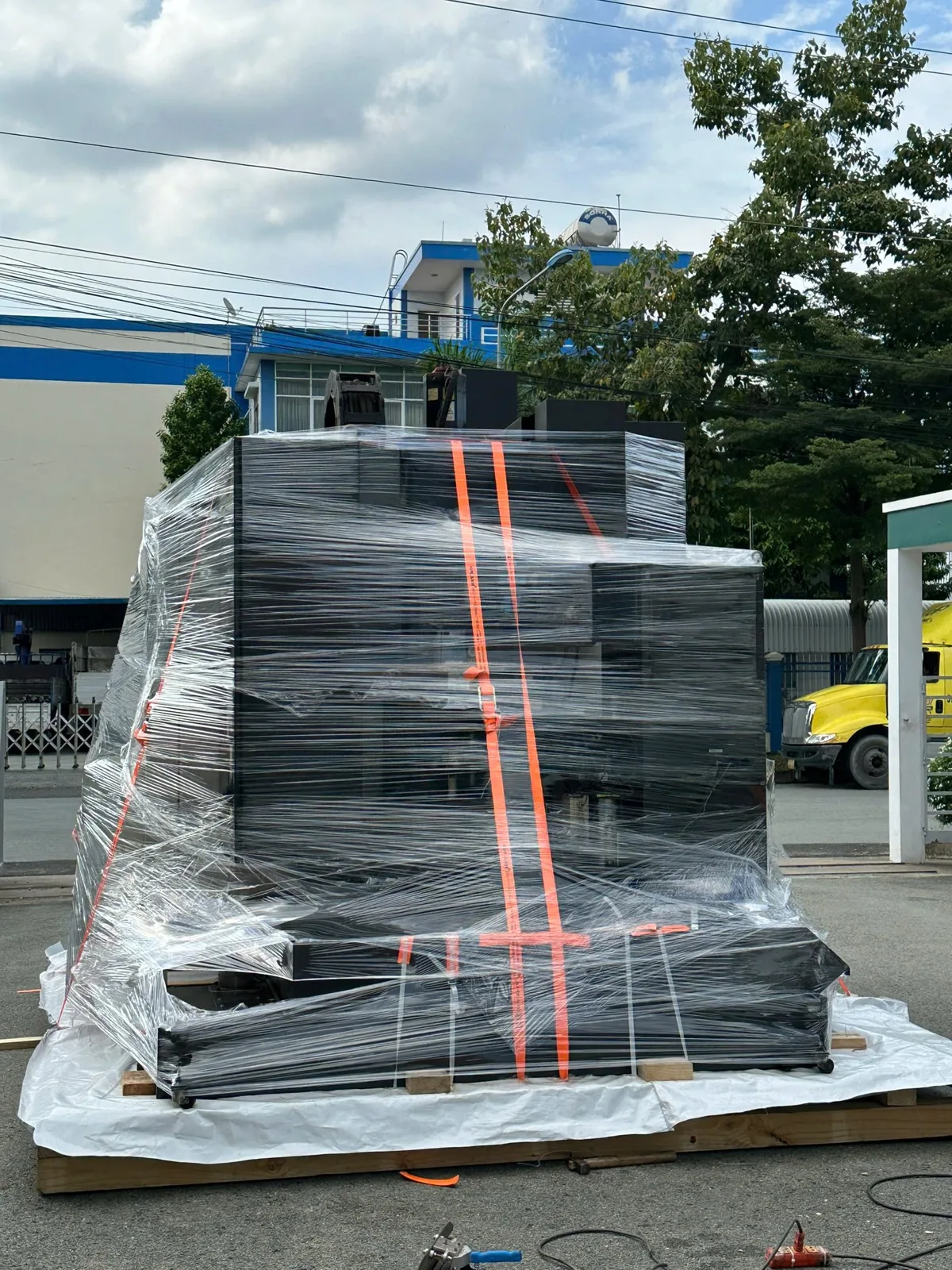 Industrial machinery secured with stretch film on a timber base