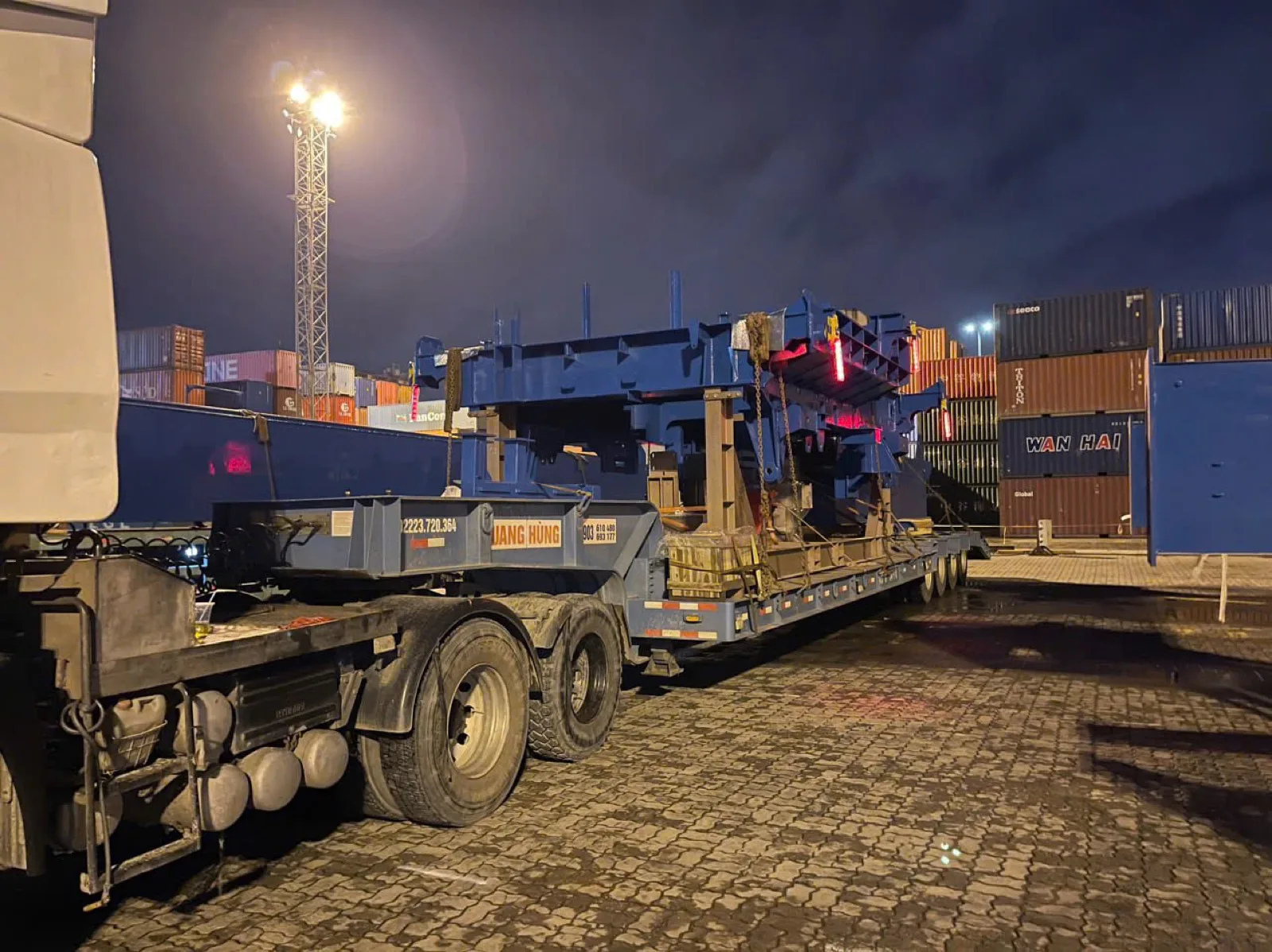 Specialised multi-axle trailer carrying oversized machinery at the port